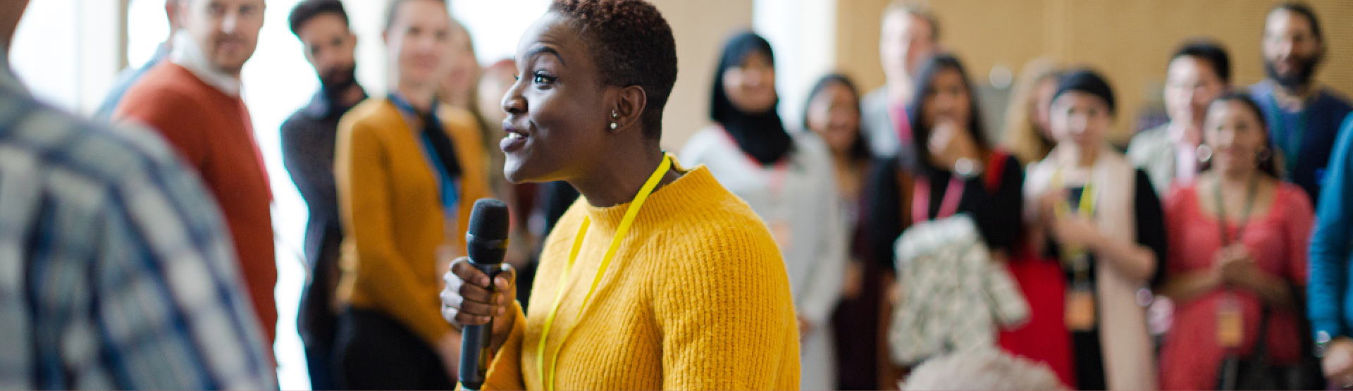 Image of a woman speaking before an audience